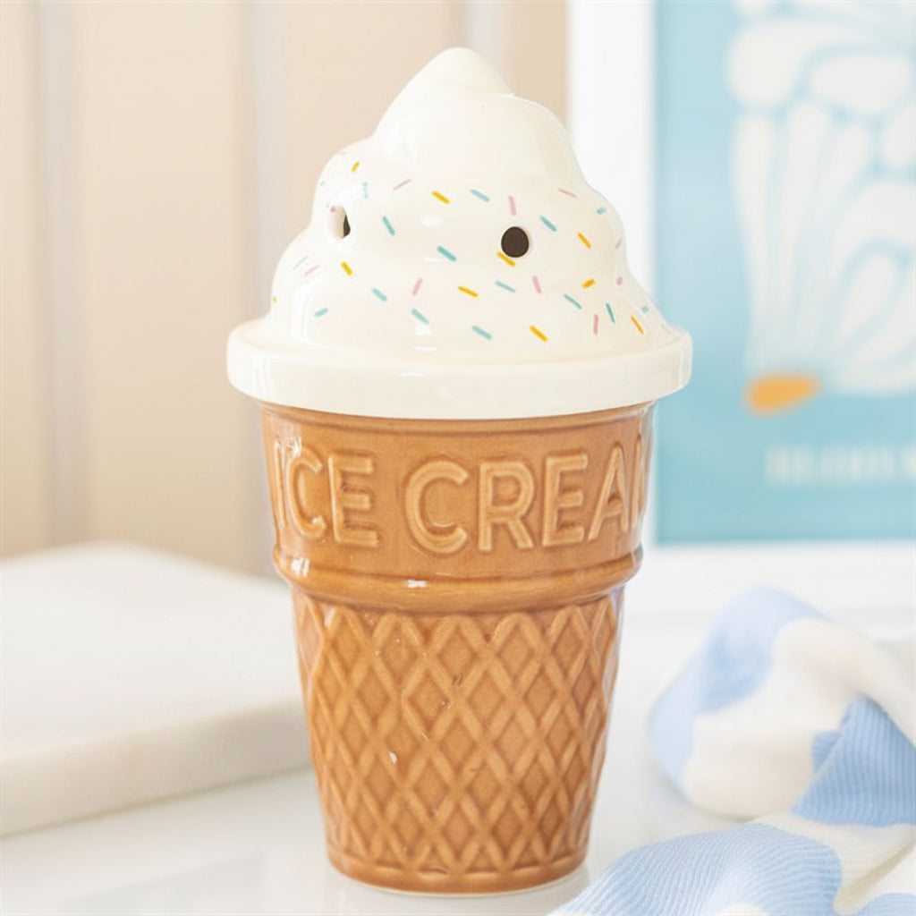 Ice cream cone-shaped ceramic burner with a lid on a surface.